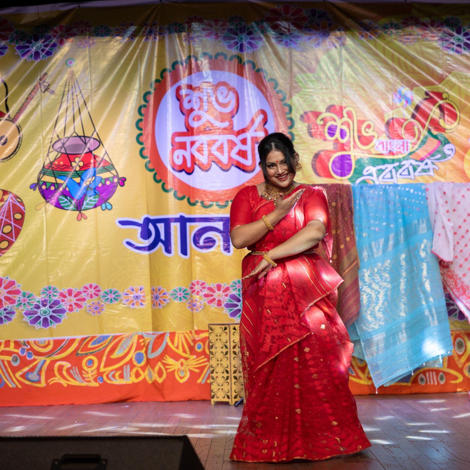 Children performing a choreographed dance in front of the Anandamela, Inc. backdrop