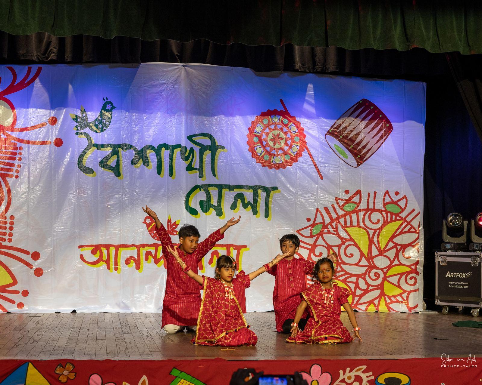 Four kids dancing with arms up