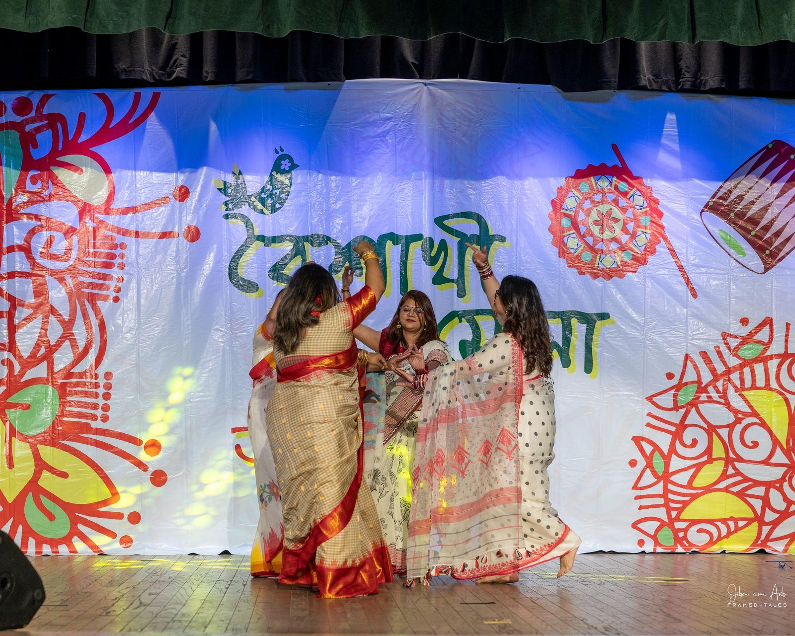Three women dancing, flowing sarees