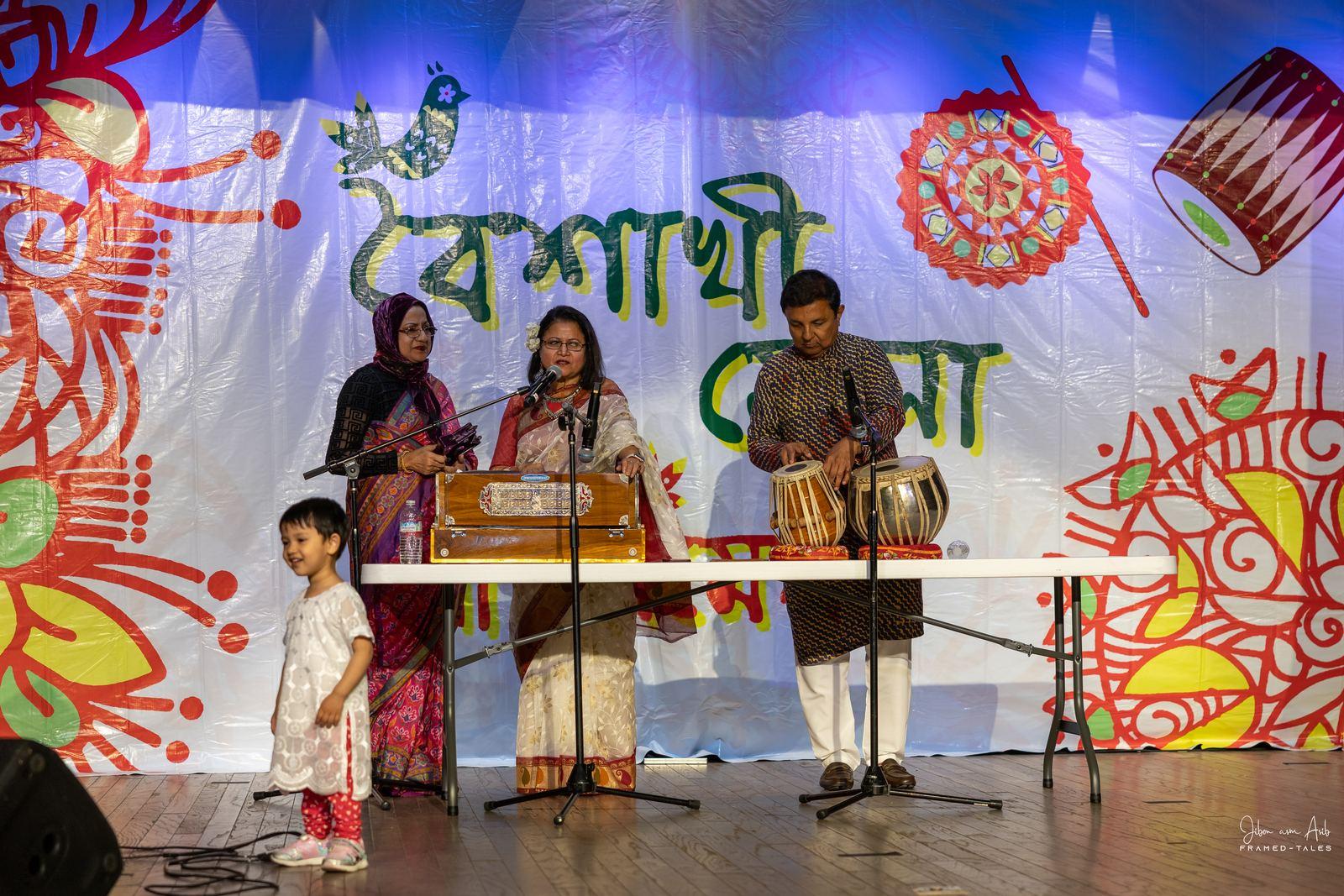 Harmonium, tabla and singer with a child nearby