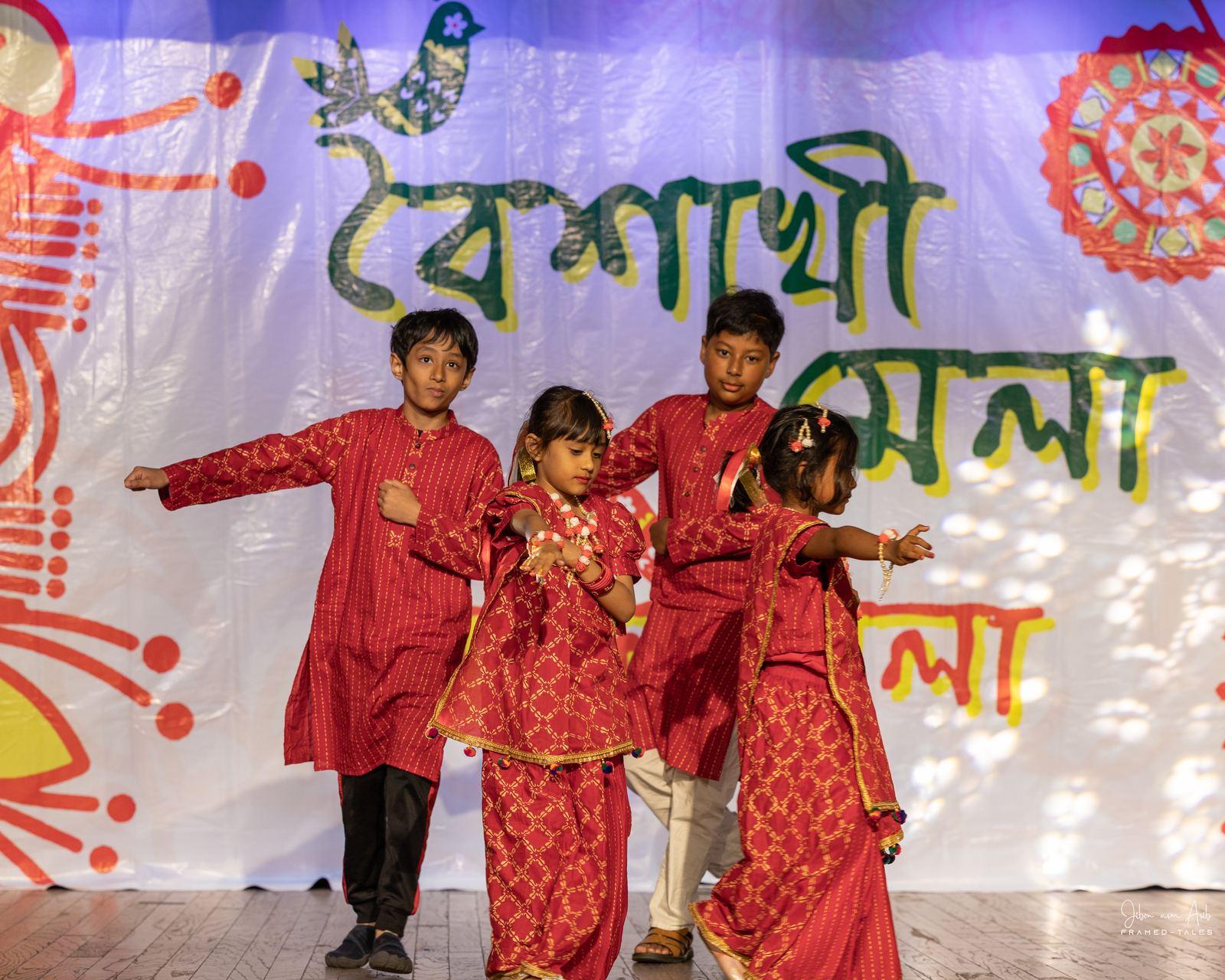 Four kids in red dancing close-up