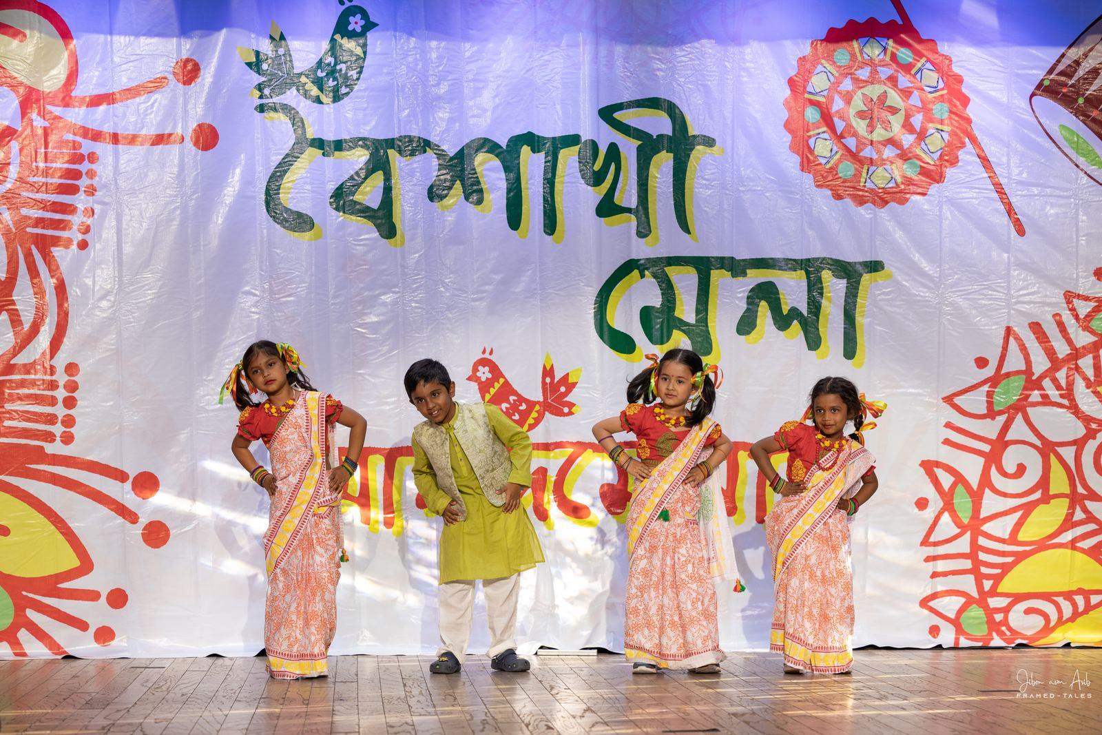 Four kids in a line doing a dance