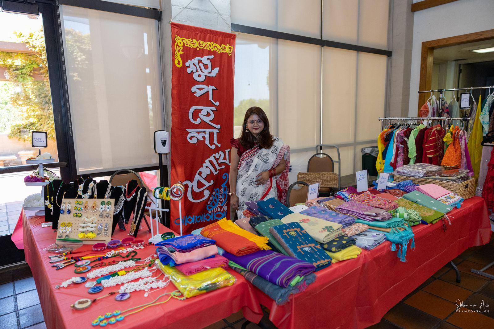 Vendor stall: jewelry and saree fabrics with "Shubho Pohela Boishakh" banner