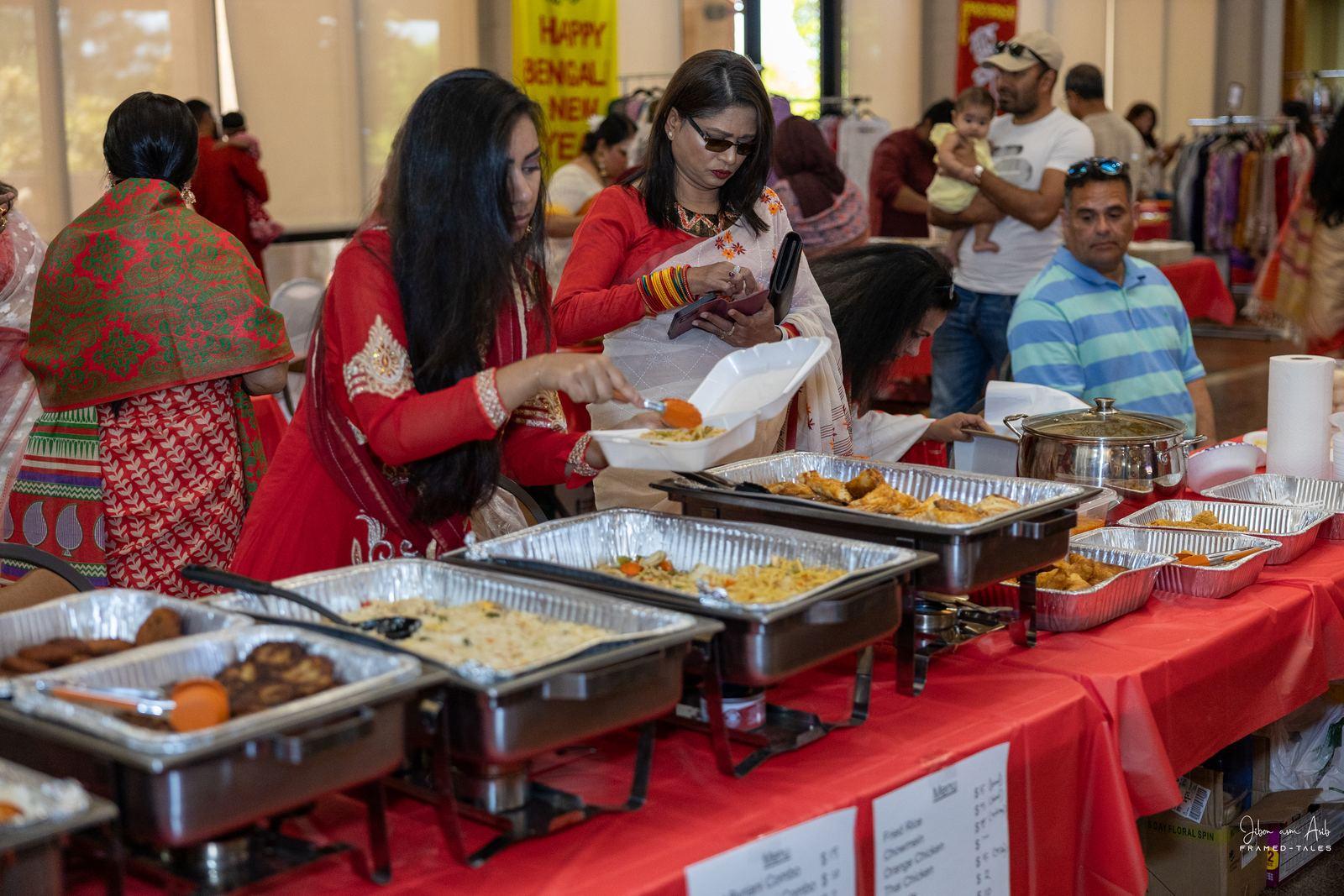 Guests filling plates at a long buffet