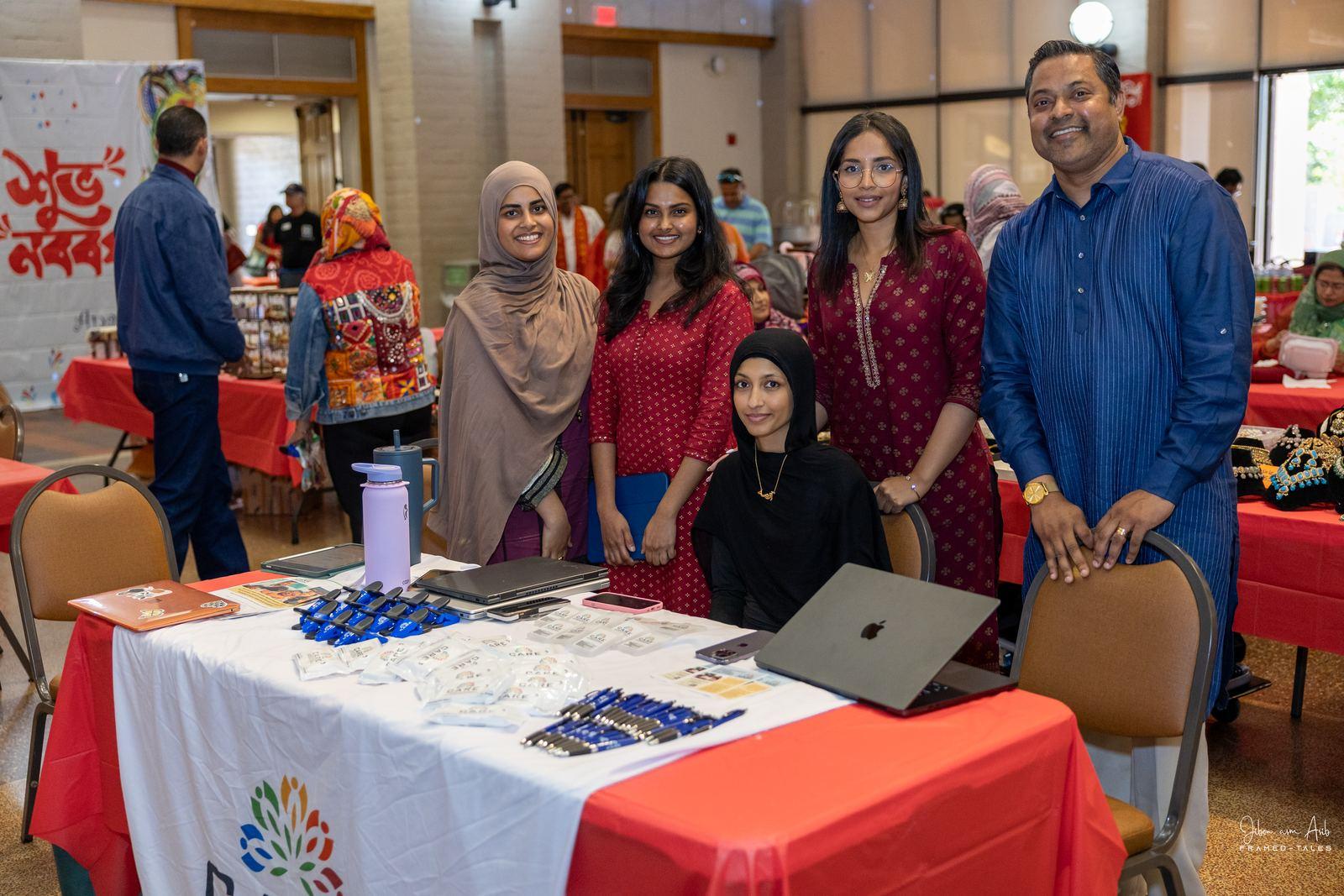 Community org table with volunteers posing