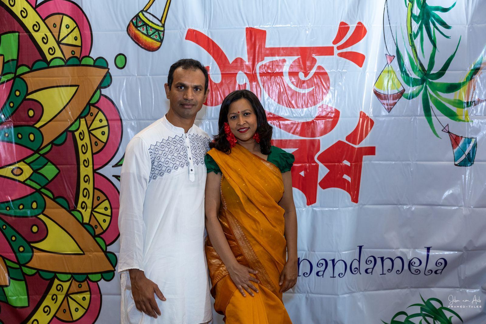 Couple in white panjabi and yellow saree at photobooth